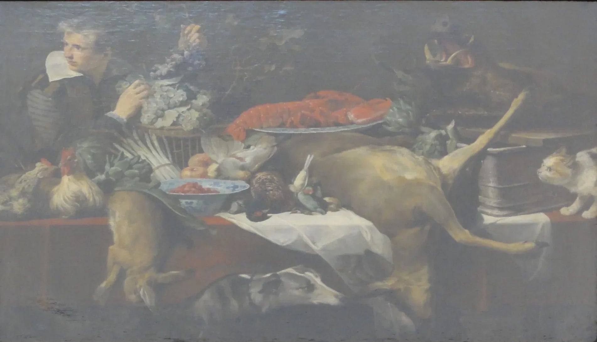 Scène de cuisine avec du gibier et des légumes, un garçon de cuisine tenant une grappe de raisin. - Frans Snyders image 1 tableau peint à l’huile sur toile