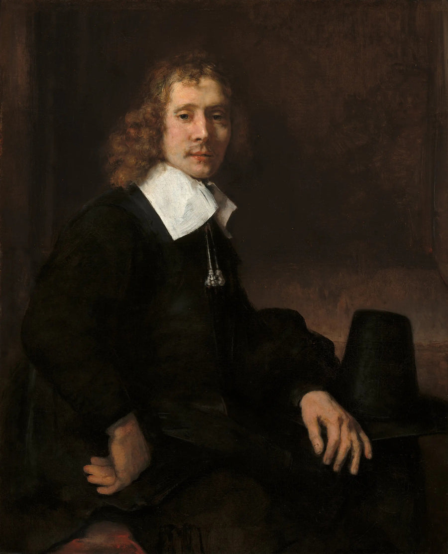 Un jeune homme assis à une table (peut-être Govaert Flinck) - Rembrandt